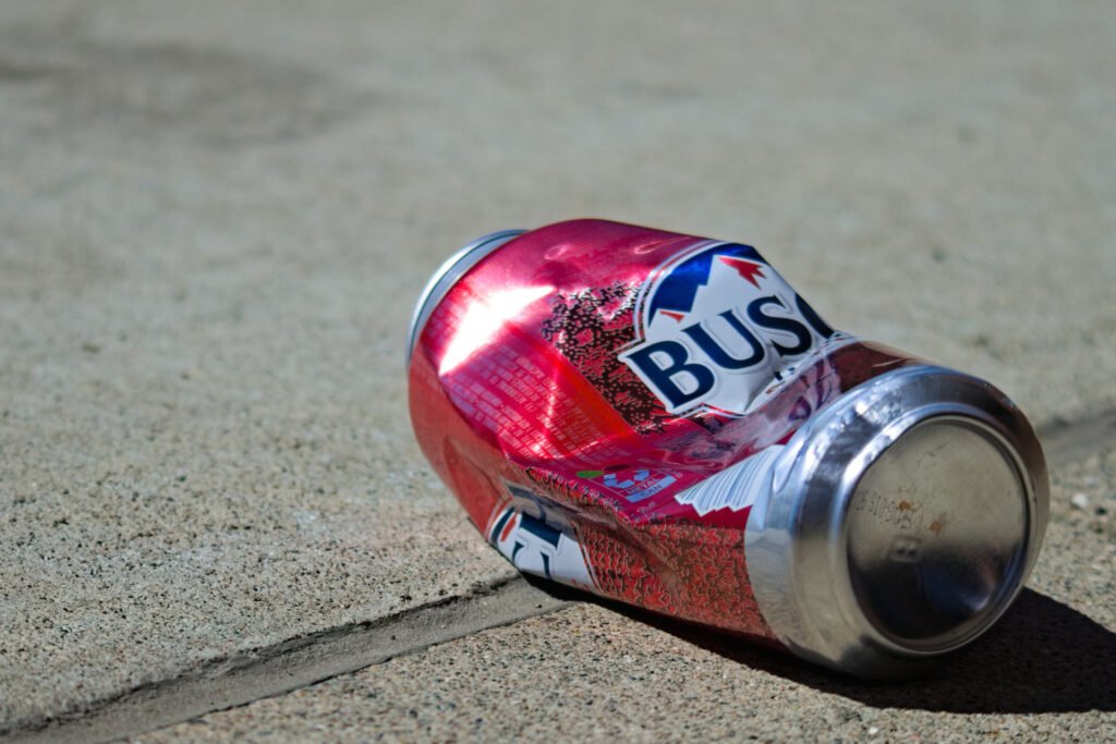 Busch Light Apple tall boy discarded and littered on a sidewalk during Purdue's Grand Prix weekend