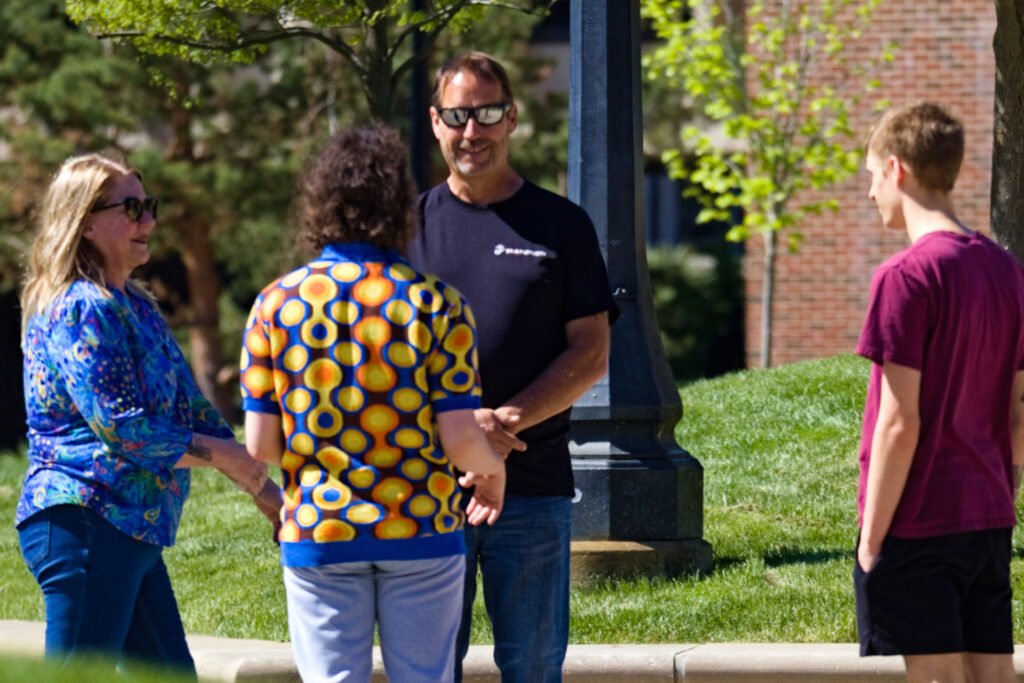A family clapping on campus during Purdue's Grand Prix weekend